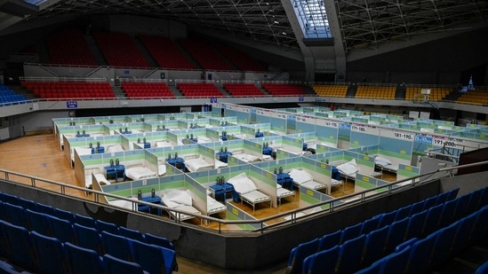 Beds lined up inside a makeshift fever clinic at a stadium in Beijing on December 20. (Jade Gao / AFP)