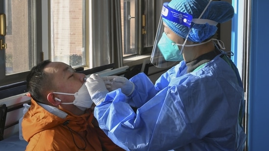 A medical worker administers a second booster dose of Covid-19 vaccine for a resident in Beijing, December 17. The end to mandatory testing has made the toll of China's Covid surge difficult to track, with authorities last week admitting it is now "impossible" to tally how many have fallen sick, Reuters reported.(Ren Chao / Xinhua via AP)