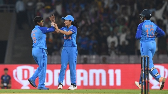 India's Deepti Sharma (L) and Renuka Singh Thakur celebrate after the dismissal of Australia's Alyssa Healy (not pictured) during the second women�s Twenty20 international cricket match between India and Australia at the DY Patil stadium in Navi Mumbai on December 11, 2022. (Photo by INDRANIL MUKHERJEE / AFP) / ----IMAGE RESTRICTED TO EDITORIAL USE - STRICTLY NO COMMERCIAL USE-----(AFP)