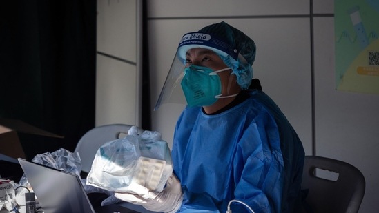 A worker in protective gear at a Covid testing station in Macau, China, on Monday. (Bloomberg)