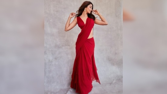 Pooja Hegde's saree comes in a clean solid shade and features ruffle detailing below the hips.(Instagram/@hegdepooja)