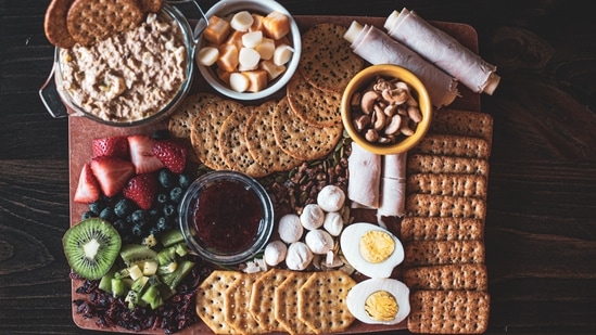 Charcuterie Board: You can put together a variety of cured meats, cheese, fruits, nuts and crackers on a board and serve it with dipping sauces. This can be a new edition to your Christmas menu if you haven't tried it earlier. (Unsplash)