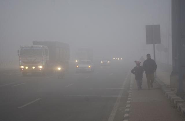 Vehicles move slowly amid dense fog on the Delhi-Meerut Expressway in Ghaziabad on Monday. (Sakib Ali/HT Photo) Vehicles move slowly amid dense fog on the Delhi-Meerut Expressway in Ghaziabad on Monday. (Sakib Ali/HT Photo)