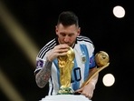 Lionel Messi kisses the World Cup trophy after receiving the Golden Ball award