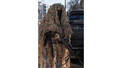 A Taliban security personnel is seen standing guard along a road in Kabul on December 21. The Taliban-led administration has not given a reason for the ban or reacted to the fierce and swift global condemnation of it. (Wakil Kohsar / AFP) A Taliban security personnel is seen standing guard along a road in Kabul on December 21. The Taliban-led administration has not given a reason for the ban or reacted to the fierce and swift global condemnation of it. (Wakil Kohsar / AFP)