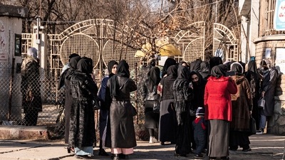 Afghan female university students stop by Taliban security personnel stand next to a university in Kabul. (AFP) Afghan female university students stop by Taliban security personnel stand next to a university in Kabul. (AFP)