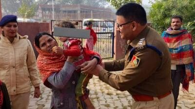 DSP (North East) Sukhwinder Pal Singh Sondhi handing over the boy to his mother in Chandigarh on Tuesday. (HT Photo)