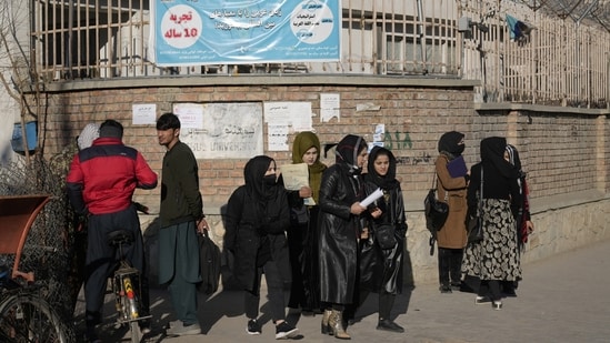 Afghan women students stand outside the Kabul University in Kabul, Afghanistan, on December 21, “Do not make education political!” members of the Unity and Solidarity of Afghanistan Women told AP, “Once again university is banned for women, we do not want to be eliminated!”&nbsp;(Ebrahim Noroozi / AP)