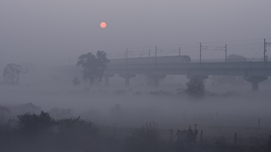 The metro is sighted in dense fog, near Akshardham Temple, in New Delhi, on December 19. On the pollution front, Delhi’s air quality was in the very poor category on December 21 morning. Data from the central pollution control board showed that the hourly air quality index (AQI) at 7am stood at 331, HT reported.(Raj K Raj / HT Photo)