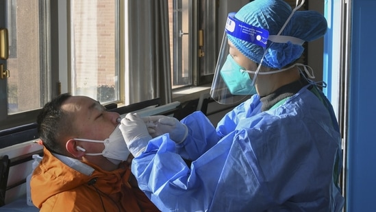 A medical worker administers a second booster dose of Covid-19 vaccine for a resident in Beijing, December 17. The end to mandatory testing has made the toll of China's Covid surge difficult to track, with authorities last week admitting it is now "impossible" to tally how many have fallen sick, Reuters reported.(Ren Chao / Xinhua via AP)