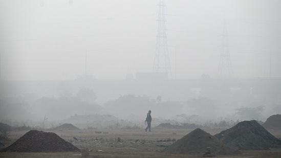 A man seen at a field engulfed in dense fog in the early morning hours at Sector 25A, Noida on December 19. According to the IMD on December 21, due to north-north westerly winds from Himalayas, cold wave conditions are likely to continue in isolated pockets of Himachal Pradesh, Punjab, Haryana and north Rajasthan for the next five days. Severe cold wave conditions are likely over Punjab on December 22 and 25, HT reported.(Sunil Ghosh / HT Photo)