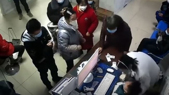 In a video, a doctor can be seen collapsing apparently from exhaustion of attending to Covid patients in a China hospital. ((The Telegraph))