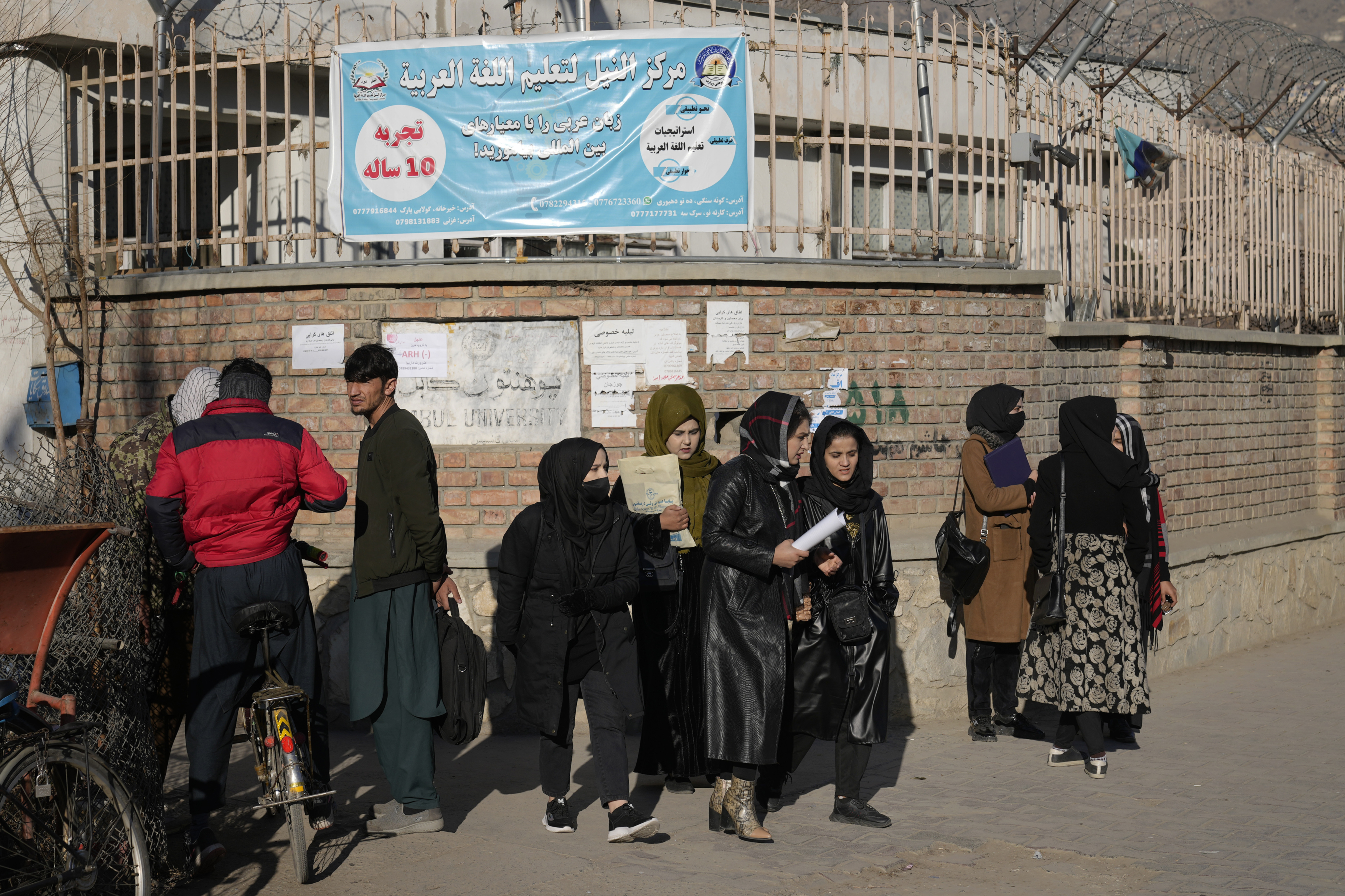 Afghan women students stand outside the Kabul University on December 21. (Ebrahim Noroozi / AP) Afghan women students stand outside the Kabul University on December 21. (Ebrahim Noroozi / AP)