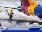 Crews deice a Southwest Airlines plane before takeoff in Omaha, Neb. Crews deice a Southwest Airlines plane before takeoff in Omaha, Neb.