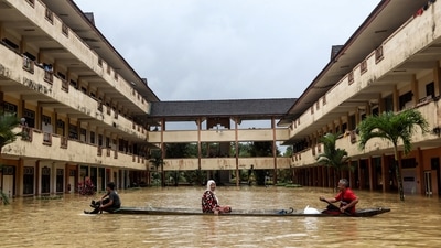 Residents are rescued by a boat from the flood relief centre after the flood water rose and partially submerged a building at Dungun, in Terengganu, Malaysia on December 21. At least five people were killed after monsoon-triggered floods inundated the country's north. authorities said, as reported by AFP. (Reuters) Residents are rescued by a boat from the flood relief centre after the flood water rose and partially submerged a building at Dungun, in Terengganu, Malaysia on December 21. At least five people were killed after monsoon-triggered floods inundated the country's north. authorities said, as reported by AFP. (Reuters)