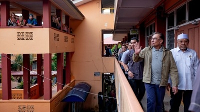 Malaysia's Prime Minister Anwar Ibrahim is seen with flood victims at a relief centre in Pasir Mas, Kelantan, on December 21. Anwar, who is also the finance minister, informed the parliament this week that the government had initially allocated 400 million Malaysian ringgit ($90 million) for the emergency, AFP reported. (Prime Minister's Office of Malaysia / Afiq Hambali/ REUTERS) Malaysia's Prime Minister Anwar Ibrahim is seen with flood victims at a relief centre in Pasir Mas, Kelantan, on December 21. Anwar, who is also the finance minister, informed the parliament this week that the government had initially allocated 400 million Malaysian ringgit ($90 million) for the emergency, AFP reported. (Prime Minister's Office of Malaysia / Afiq Hambali/ REUTERS)