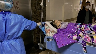 This picture shows a Covid-19 patient on a stretcher in the emergency ward of the First Affiliated Hospital of Chongqing Medical University in China's southwestern city of Chongqing. (AFP)