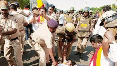 Police personnel detain Karnataka Rakshana Vedike supporters during a protest over the Maharashtra-Karnataka border dispute, at Hire Bagewadi, in Belagavi on Tuesday. (ANI) Police personnel detain Karnataka Rakshana Vedike supporters during a protest over the Maharashtra-Karnataka border dispute, at Hire Bagewadi, in Belagavi on Tuesday. (ANI)