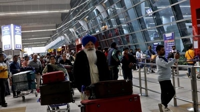 Travellers push trolleys with their luggage at the departure area of the Indira Gandhi International Airport in New Delhi. (REUTERS) Travellers push trolleys with their luggage at the departure area of the Indira Gandhi International Airport in New Delhi. (REUTERS)