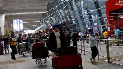 Travellers push trolleys with their luggage at the departure area of the Indira Gandhi International Airport in New Delhi. (REUTERS) Travellers push trolleys with their luggage at the departure area of the Indira Gandhi International Airport in New Delhi. (REUTERS)