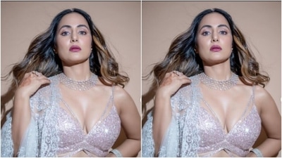 Hina looked stunning as ever in the slip silver blouse with a plunging neckline and knot details at the back. She further teamed it with a long and flowy silver skirt featuring silver tulle details and embroidery work in silver resham threads. (Instagram/@realhinakhan) Hina looked stunning as ever in the slip silver blouse with a plunging neckline and knot details at the back. She further teamed it with a long and flowy silver skirt featuring silver tulle details and embroidery work in silver resham threads. (Instagram/@realhinakhan)