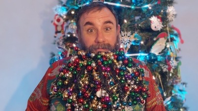 Joel Strasser attached 710 baubles, decorative balls hung on a Christmas tree, to his beard to enter Guinness World Record. (Guinness World Records)