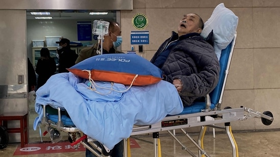 An elderly covid-19 coronavirus patient lies on a stretcher at the emergency ward of the First Affiliated Hospital of Chongqing Medical University in China's southwestern city of Chongqing. (AFP)