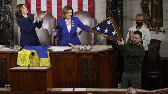 Ukrainian President Volodymyr Zelenskyy holds an American flag that was gifted to him by House Speaker Nancy Pelosi of Calif., after he addressed a joint meeting of Congress on Capitol Hill in Washington, Wednesday, Dec. 21, 2022. House Speaker Nancy Pelosi of Calif., second from left, and Vice President Kamala Harris, left. (AP Photo/Carolyn Kaster)(AP)