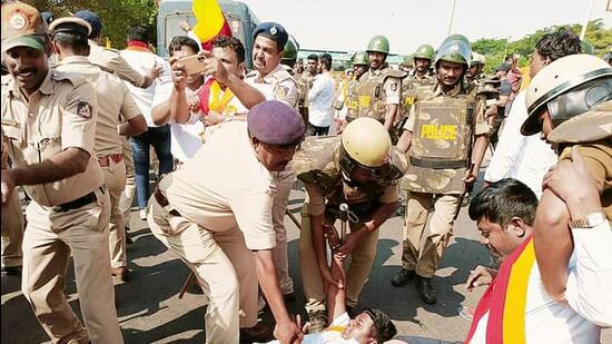 Police personnel detain Karnataka Rakshana Vedike supporters during a protest over the Maharashtra-Karnataka border dispute, at Hire Bagewadi, in Belagavi on Tuesday. (ANI) Police personnel detain Karnataka Rakshana Vedike supporters during a protest over the Maharashtra-Karnataka border dispute, at Hire Bagewadi, in Belagavi on Tuesday. (ANI)