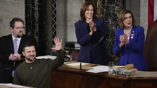 Ukrainian President Volodymyr Zelenskyy gestures towards the guests of the the Ukrainian delegation as he addresses a joint meeting of Congress on Capitol Hill in Washington, Wednesday, Dec. 21, 2022. Vice President Kamala Harris and House Speaker Nancy Pelosi of Calif., look on. (AP Photo/Jacquelyn Martin)(AP)