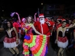 A man dressed in a Santa Claus outfit dances with others during Christmas celebrations in Mumbai, India. Indian Medical Association advises people to avoid public gatherings, international travel amid fresh Covid-19 scare 