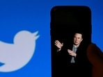 (FILES) In this file photo taken on October 4, 2022, a phone screen displays a photo of Elon Musk with the Twitter logo shown in the background, (AFP) (FILES) In this file photo taken on October 4, 2022, a phone screen displays a photo of Elon Musk with the Twitter logo shown in the background, (AFP)