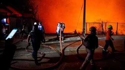 Firefighters work to control the huge fire. (AFP) Firefighters work to control the huge fire. (AFP)