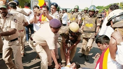 Police personnel detain Karnataka Rakshana Vedike supporters during a protest over the Maharashtra-Karnataka border dispute, at Hire Bagewadi, in Belagavi on Tuesday. (ANI) Police personnel detain Karnataka Rakshana Vedike supporters during a protest over the Maharashtra-Karnataka border dispute, at Hire Bagewadi, in Belagavi on Tuesday. (ANI)