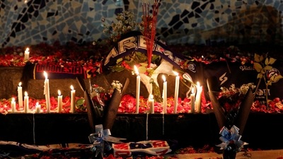 Indonesia Stampede Accident: Candles, petals, and incenses placed by Arema FC supporters are seen during a vigil to pay condolence to the victims. (Reuters)