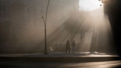 People walk in the street amid dense fog at morning at Terazije square in downtown Belgrade, Serbia. (AP Photo/Darko Vojinovic) (File)