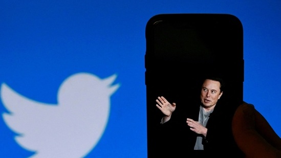 (FILES) In this file photo taken on October 4, 2022, a phone screen displays a photo of Elon Musk with the Twitter logo shown in the background, (AFP) (FILES) In this file photo taken on October 4, 2022, a phone screen displays a photo of Elon Musk with the Twitter logo shown in the background, (AFP)