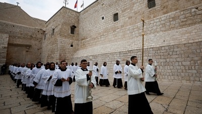 Clergy members are seen at Christmas celebrations, with the Latin Patriarch of Jerusalem, Pierbattista Pizzaballa, in Bethlehem, on December 24. (Mohamad Torokman / Reuters) Clergy members are seen at Christmas celebrations, with the Latin Patriarch of Jerusalem, Pierbattista Pizzaballa, in Bethlehem, on December 24. (Mohamad Torokman / Reuters)