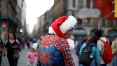 A man in a Spider-man costume is seen wearing a Santa Claus hat ahead of Christmas at Zocalo Square in Mexico City, on December 23. (Raquel Cunha / Reuters) A man in a Spider-man costume is seen wearing a Santa Claus hat ahead of Christmas at Zocalo Square in Mexico City, on December 23. (Raquel Cunha / Reuters)