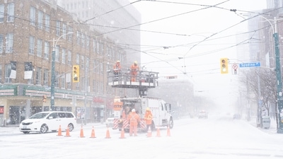 Workers repair wires damaged by high winds during a snowstorm in Canada. (AP) Workers repair wires damaged by high winds during a snowstorm in Canada. (AP)