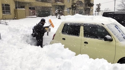 Japan Snowfall: A man clears snow at a parking lot in Kitami, Hokkaido Prefecture, Japan. (Reuters)