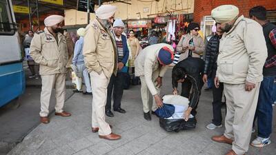 Punjab Police personnel conducting a security check at Patiala bus terminal. (ANI)