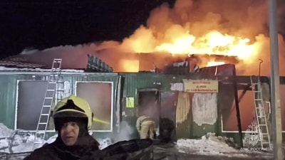 Firefighters work to extinguish a fire in an unregistered home for the elderly in the Siberian city of Kemerovo, Russia. (via REUTERS)