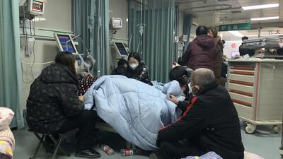 Relatives gather near the bed of a sick patient at the emergency department of the Langfang No 4 People’s Hospital in Bazhou city in northern China'\’s Hebei province on Thursday. (AP) Relatives gather near the bed of a sick patient at the emergency department of the Langfang No 4 People’s Hospital in Bazhou city in northern China'\’s Hebei province on Thursday. (AP)