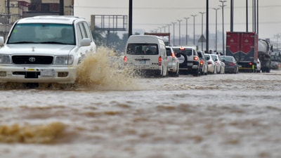 Saudi Arabia Flash Floods: Cars drive through a flooded street following heavy rains. (AFP)