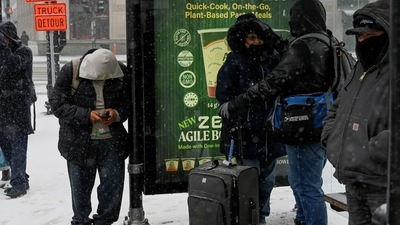 Bomb Cyclone In US: People wait at a CTA bus stop during cold weather. (Reuters)