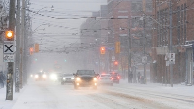 Cars drive through blowing snow during a snowstorm in Toronto, Canada on Friday. In US, a 50-vehicle pileup on the Ohio Turnpike in a blizzard near Toledo killed two motorists, and injured numerous others. (AP) Cars drive through blowing snow during a snowstorm in Toronto, Canada on Friday. In US, a 50-vehicle pileup on the Ohio Turnpike in a blizzard near Toledo killed two motorists, and injured numerous others. (AP)