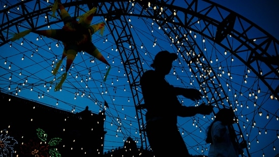 People visit the Christmas fair set up at the Zocalo square in Mexico City, on December 23.(Pedro Pardo / AFP)