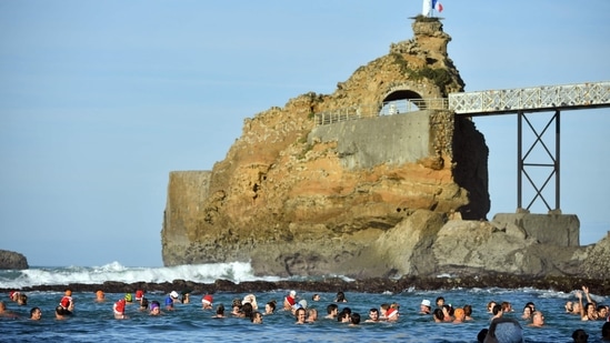 Bathers are seen at the traditional Christmas Swim organised since 1929 by "Les Ours blancs" (polar bears) association at the beach of Port Vieux in Biarritz, southwestern France, on December 24.&nbsp;(Gaiza Iroz / AFP)