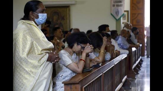 Devotees praying at a church in Pune. (Rahul Raut/HT Photo)